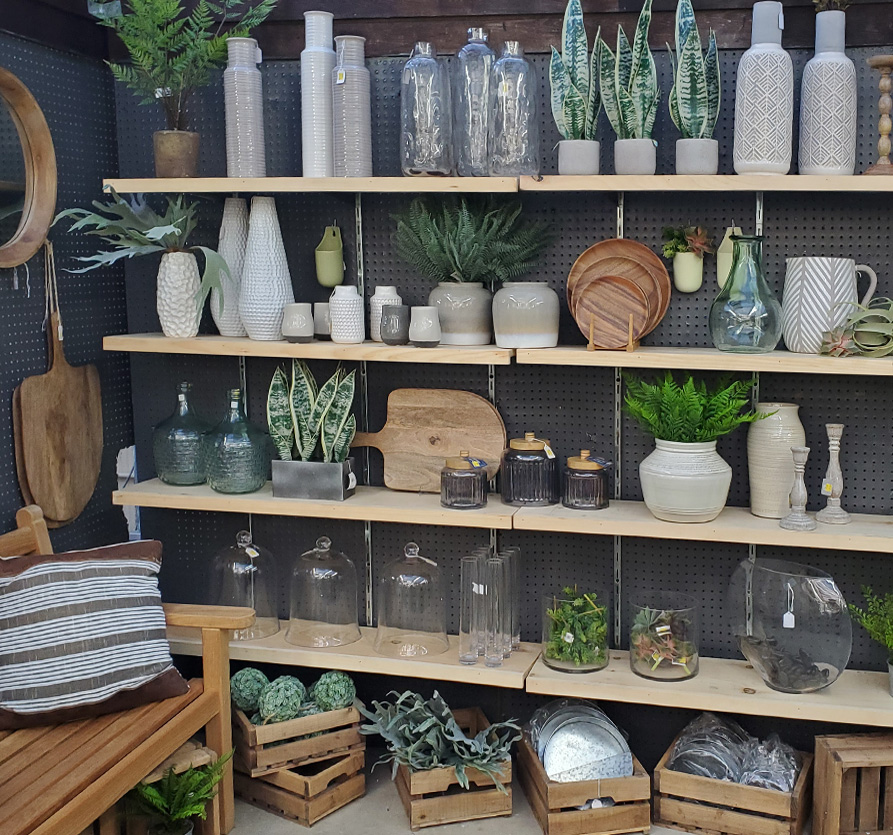 Stocking out shelves full of ceramics, vases and rustic country decor